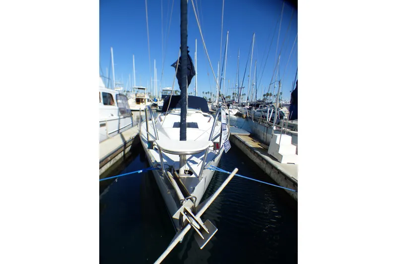 1994 Hunter Legend 35.5 sailboat docked in a marina under clear blue skies.