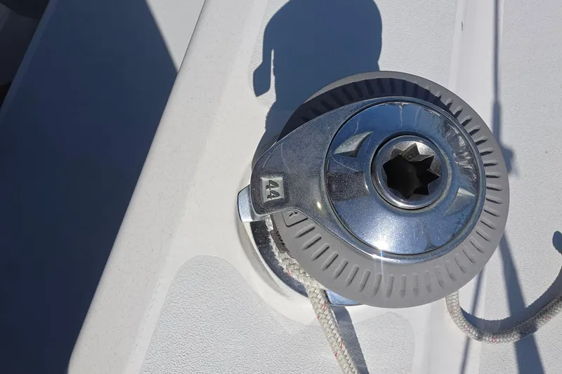 Winch on 1994 Hunter Legend 35.5 sailboat deck, sunlight reflecting on metal.