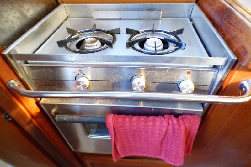 Stove in 1994 Hunter Legend 35.5 yacht kitchen with red towel.