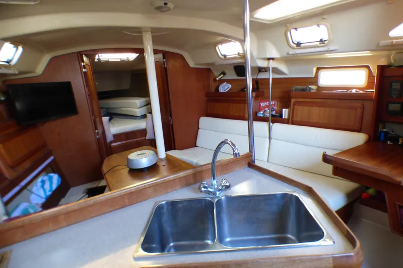 Interior of 1994 Hunter Legend 35.5 sailboat with cozy seating and kitchen area.