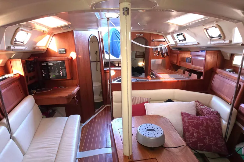 Interior of 1994 Hunter Legend 35.5 sailboat with wood finish and cozy seating area.