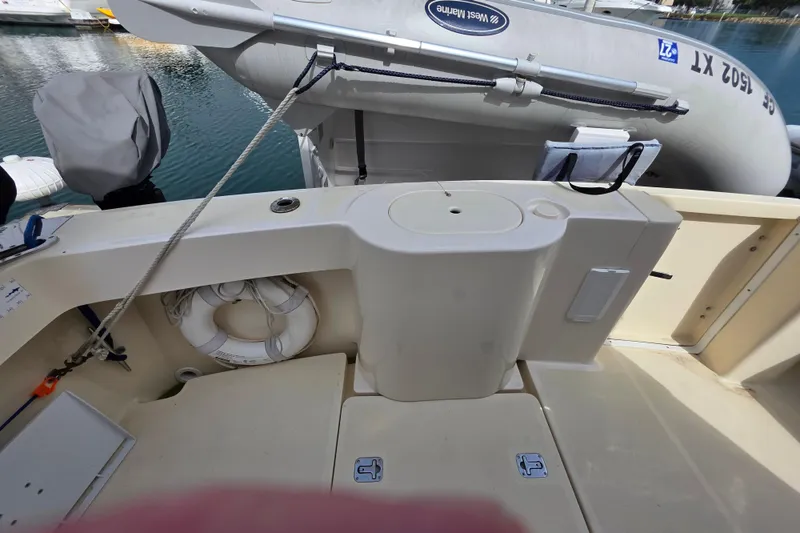 2005 Mainship 34 Pilot Sedan Rum Runner II boat deck with life preserver and dinghy.