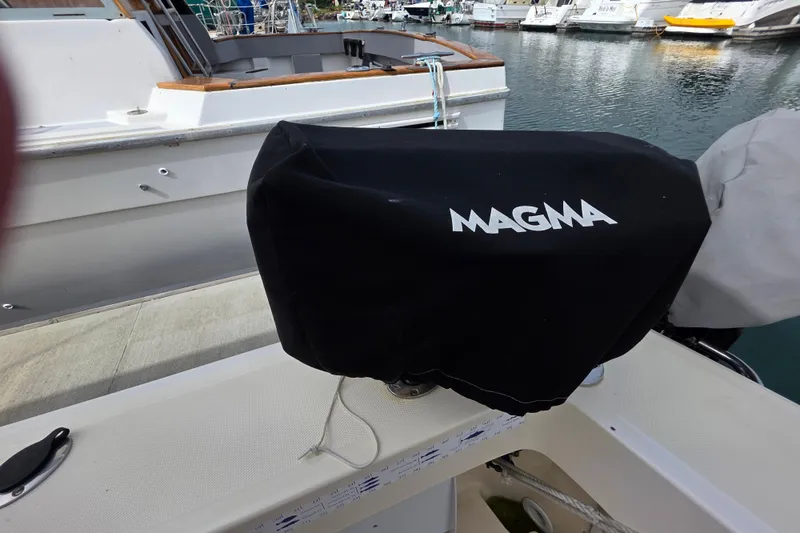 Covered Magma grill on 2005 Mainship 34 Pilot Sedan Rum Runner II boat deck.