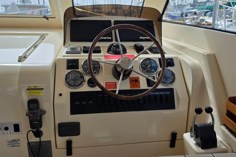 2005 Mainship 34 Pilot Sedan Rum Runner II helm with steering wheel and control panel.