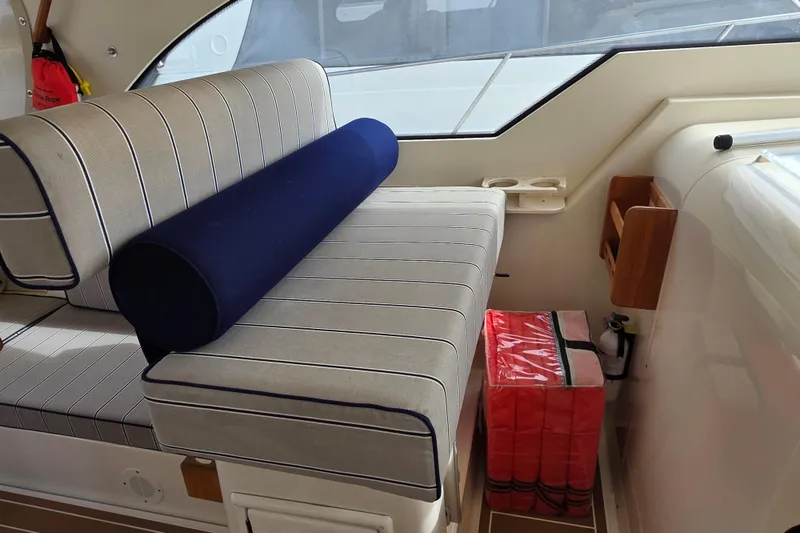 2005 Mainship 34 Pilot Sedan Rum Runner II interior with striped seating and safety equipment.