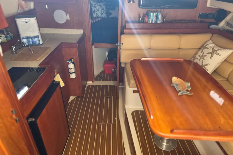 Interior of 2005 Mainship 34 Pilot Sedan Rum Runner II with kitchenette and seating area.