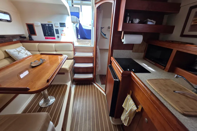 2005 Mainship 34 Pilot Sedan Rum Runner II interior with kitchen and dining area.