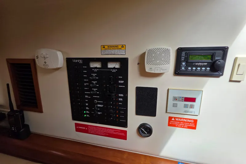 Control panel of 2005 Mainship 34 Pilot Sedan Rum Runner II with various gauges and warnings.