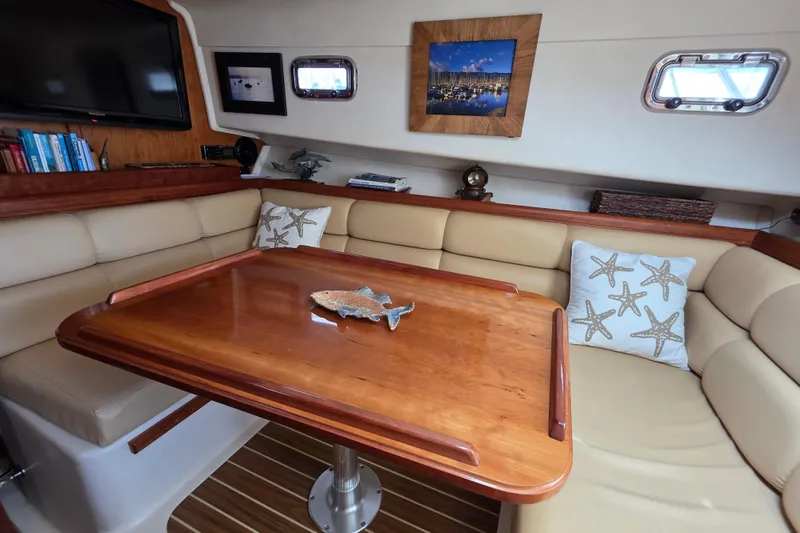 Luxurious 2005 Mainship 34 Pilot Sedan Rum Runner II interior with cozy seating and elegant decor.