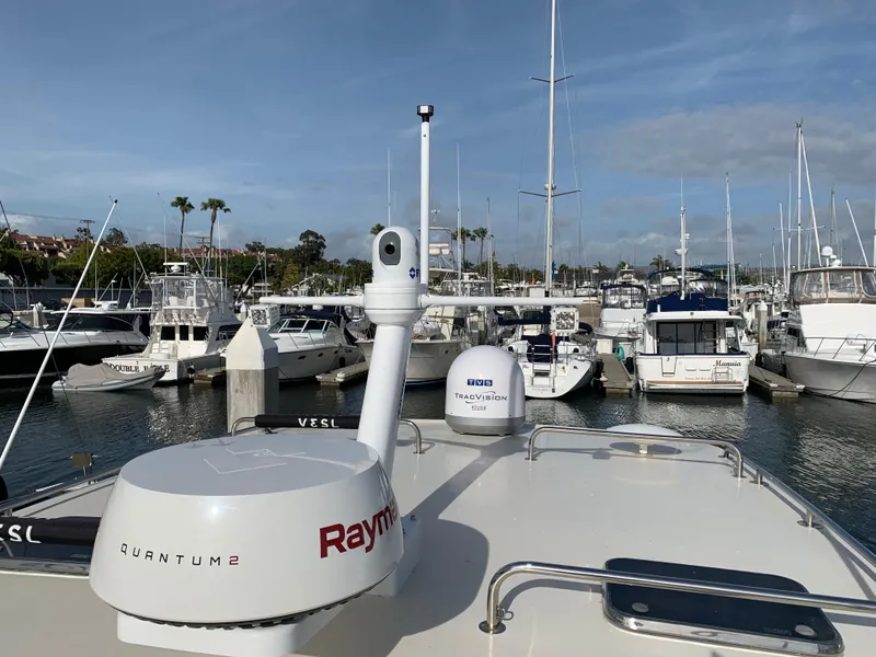 2005 Mainship 34 Pilot Sedan Rum Runner II docked in a marina with navigation equipment.