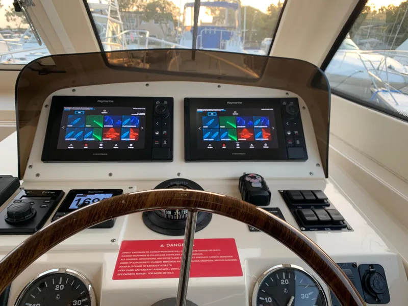 Helm of 2005 Mainship 34 Pilot Sedan Rum Runner II with dual navigation screens.