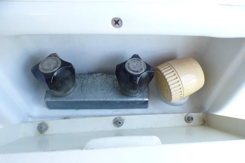 Close-up of Hunter 40.5 1993 boat shower controls with knobs and spray nozzle.