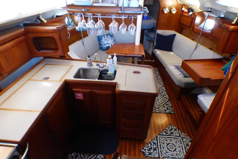 Interior of 1993 Hunter 40.5 sailboat with cozy seating and kitchen area.