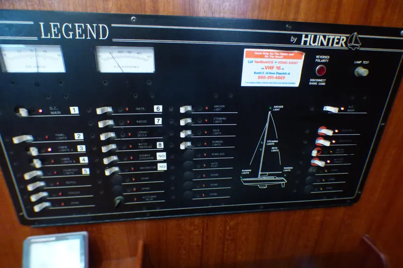 Control panel of a 1993 Hunter 40.5 sailboat with various switches and indicators.