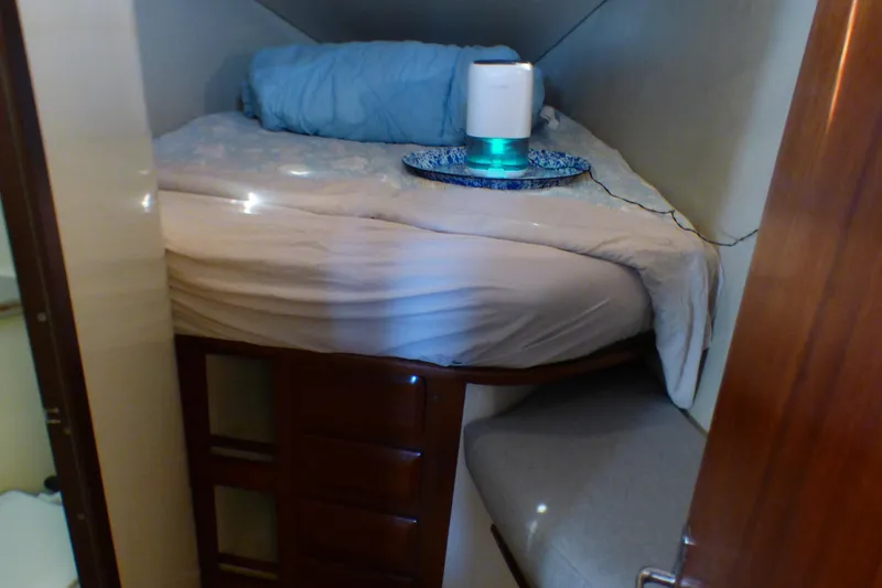 Cozy cabin interior of 1993 Hunter 40.5 sailboat with bed and storage.