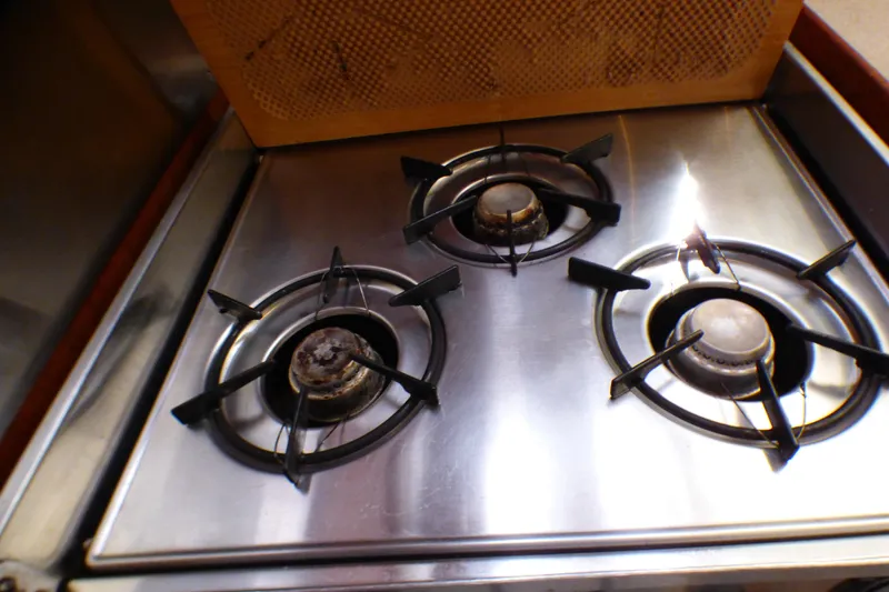 Three-burner stainless steel stove on a 1993 Hunter 40.5 model yacht.