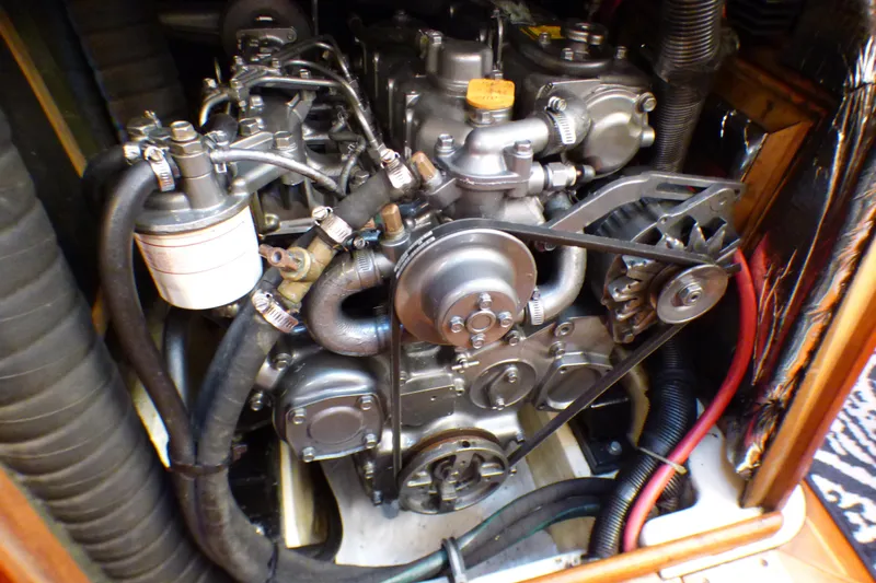 Engine of a 1993 Hunter 40.5 sailboat, showcasing mechanical components and hoses.