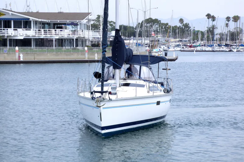 Sailboat Hunter 40.5, 1993 model, docked in marina with waterfront view.