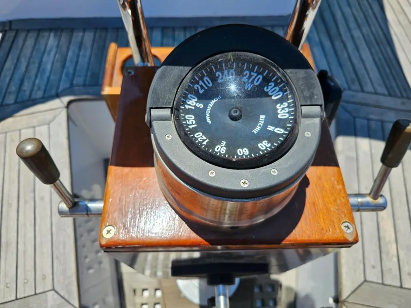 Compass on 1985 Spindrift Pilot House Cutter's wooden helm station.