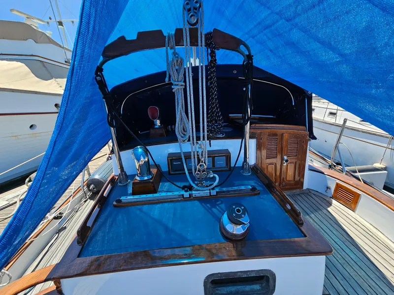 1985 Spindrift Pilot House Cutter sailboat deck with blue tarp cover.