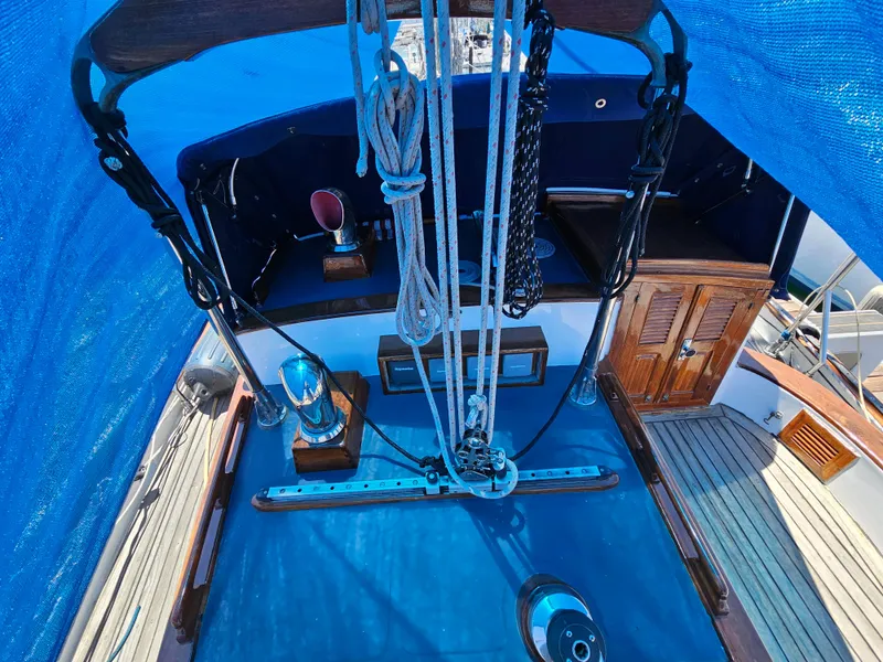 Cockpit of 1985 Spindrift Pilot House Cutter under blue tarp.