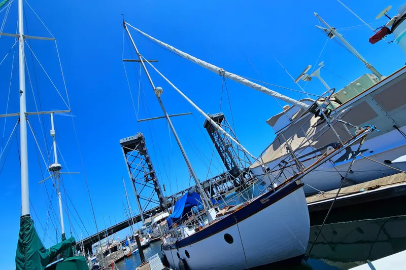 1985 Spindrift Pilot House Cutter docked at a marina under a clear blue sky.