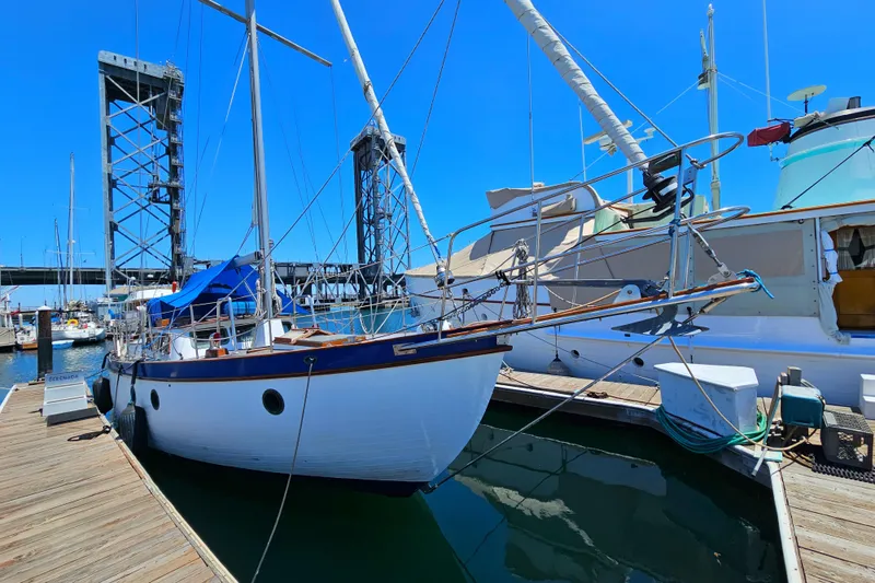 1985 Spindrift Pilot House Cutter docked at a marina on a sunny day.