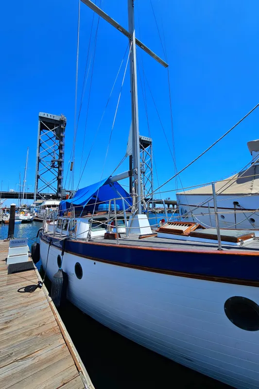 1985 Spindrift Pilot House Cutter docked at marina under clear blue sky.