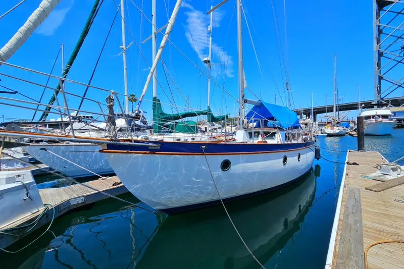 1985 Spindrift Pilot House Cutter docked at a marina on a sunny day.