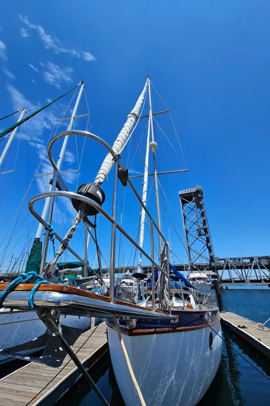 1985 Spindrift Pilot House Cutter docked at a marina under a clear blue sky.