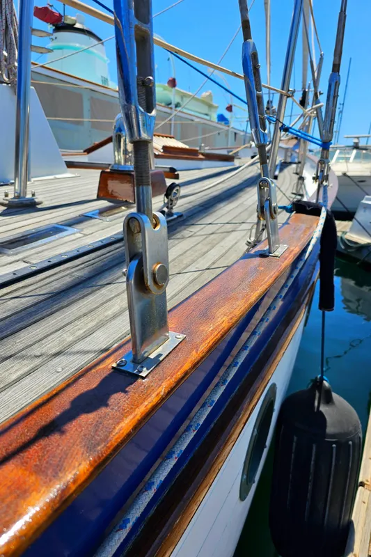1985 Spindrift Pilot House Cutter sailboat deck with polished wood and rigging.