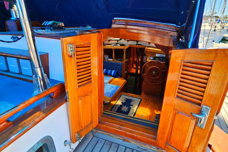 1985 Spindrift Pilot House Cutter interior with wooden doors and nautical decor.