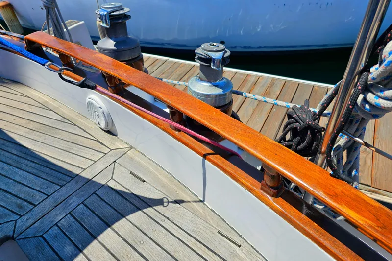 1985 Spindrift Pilot House Cutter deck with winches and wooden rail.