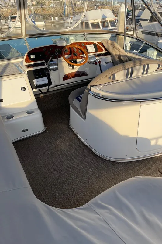 1997 Maxum 4600 SCB yacht cockpit with steering wheel and control panel.