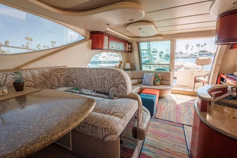 Luxurious interior of 1997 Maxum 4600 SCB yacht with elegant seating and vibrant decor.