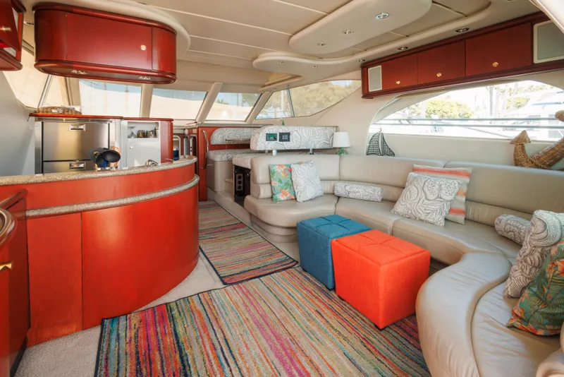 Luxurious 1997 Maxum 4600 SCB yacht interior with modern kitchen, colorful decor, and spacious seating.