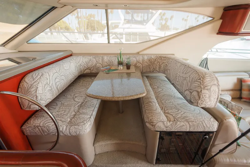 1997 Maxum 4600 SCB yacht interior with patterned seating and a central table.