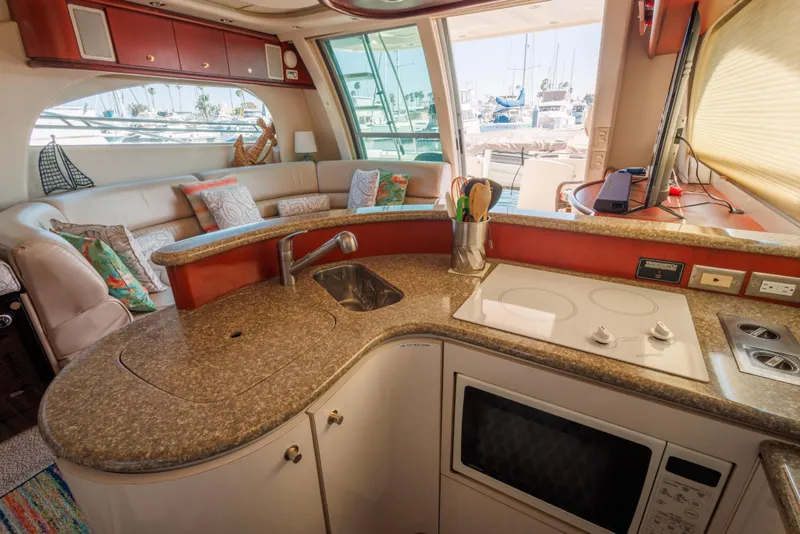 Luxurious 1997 Maxum 4600 SCB yacht interior with modern kitchen and cozy seating area.