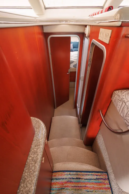 Interior of 1997 Maxum 4600 SCB yacht, featuring a narrow hallway and carpeted stairs.