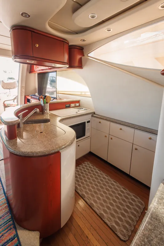 Luxurious kitchen interior of 1997 Maxum 4600 SCB yacht with modern amenities.