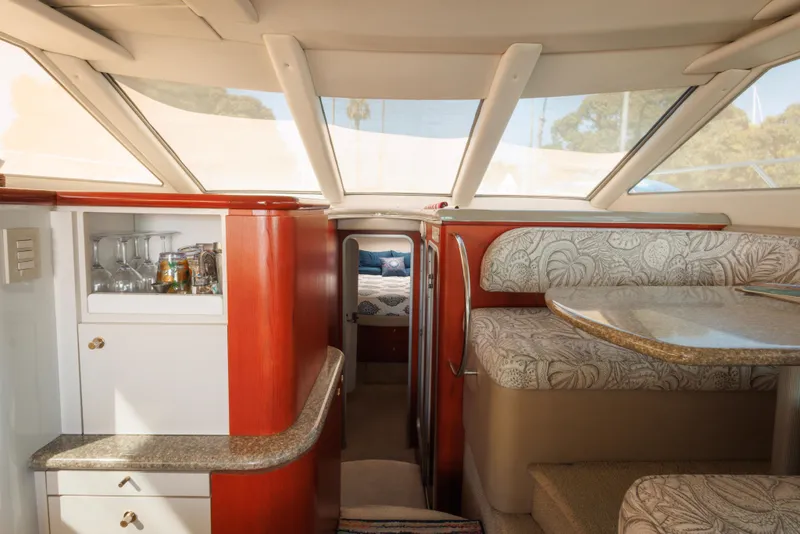 Luxurious interior of 1997 Maxum 4600 SCB yacht with elegant seating and bar area.