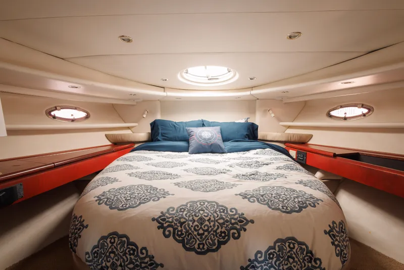 Luxurious cabin interior of 1997 Maxum 4600 SCB yacht with elegant bedding.