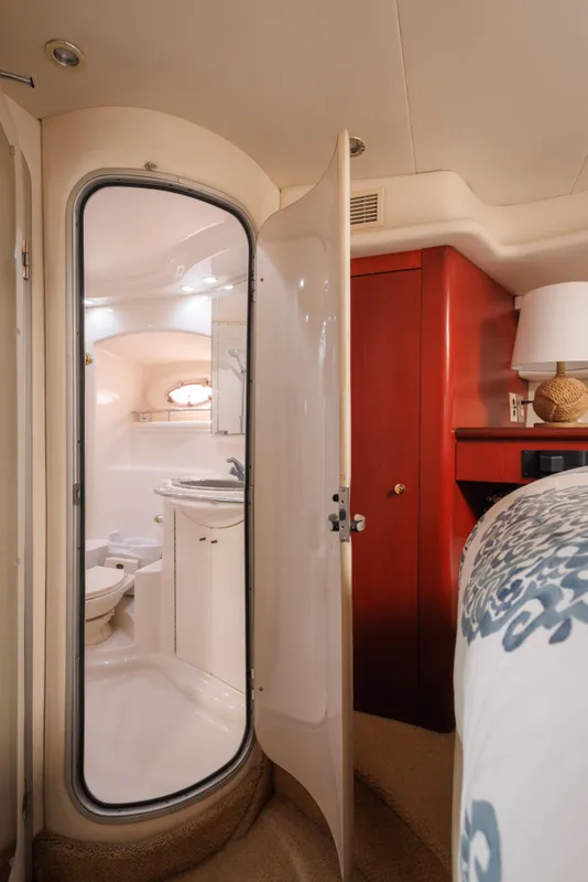 1997 Maxum 4600 SCB yacht interior with bathroom, red cabinet, and bed.