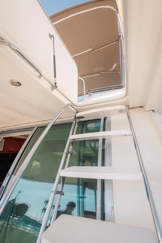Staircase on 1997 Maxum 4600 SCB yacht leading to upper deck.