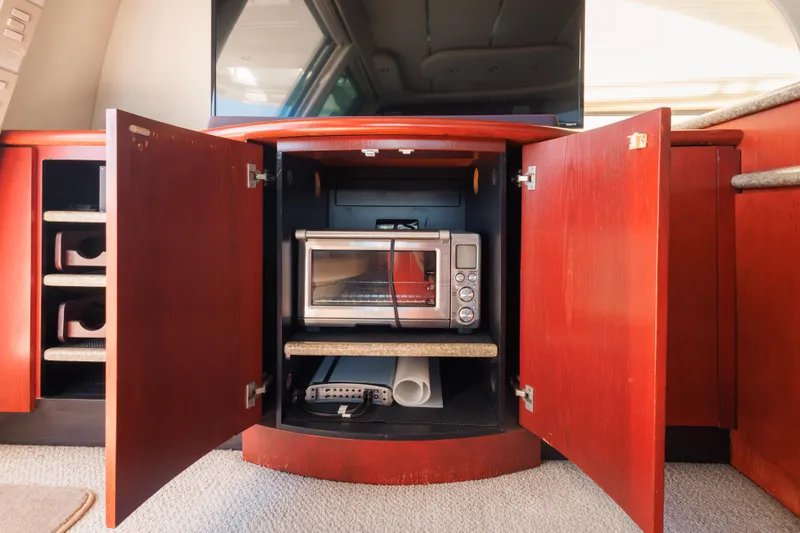 1997 Maxum 4600 SCB yacht interior with open cabinet revealing a toaster oven.