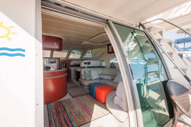 Interior of 1997 Maxum 4600 SCB yacht with cozy seating and colorful decor.