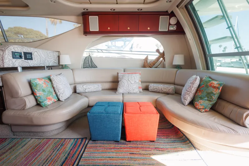 Luxurious 1997 Maxum 4600 SCB yacht interior with plush seating and colorful cushions.