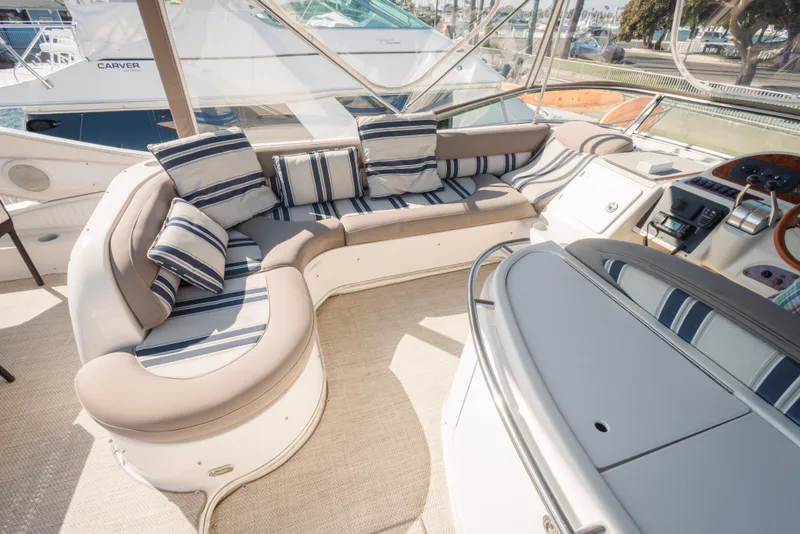 Luxurious seating area on a 1997 Maxum 4600 SCB yacht with striped cushions.