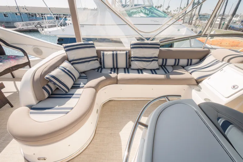 Luxurious seating area on a 1997 Maxum 4600 SCB yacht with striped cushions.