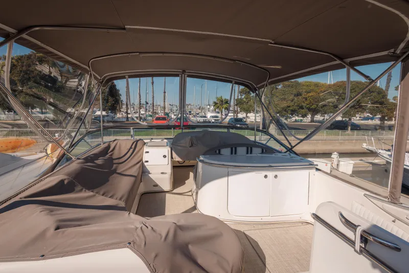 1997 Maxum 4600 SCB yacht interior with covered seating and marina view.